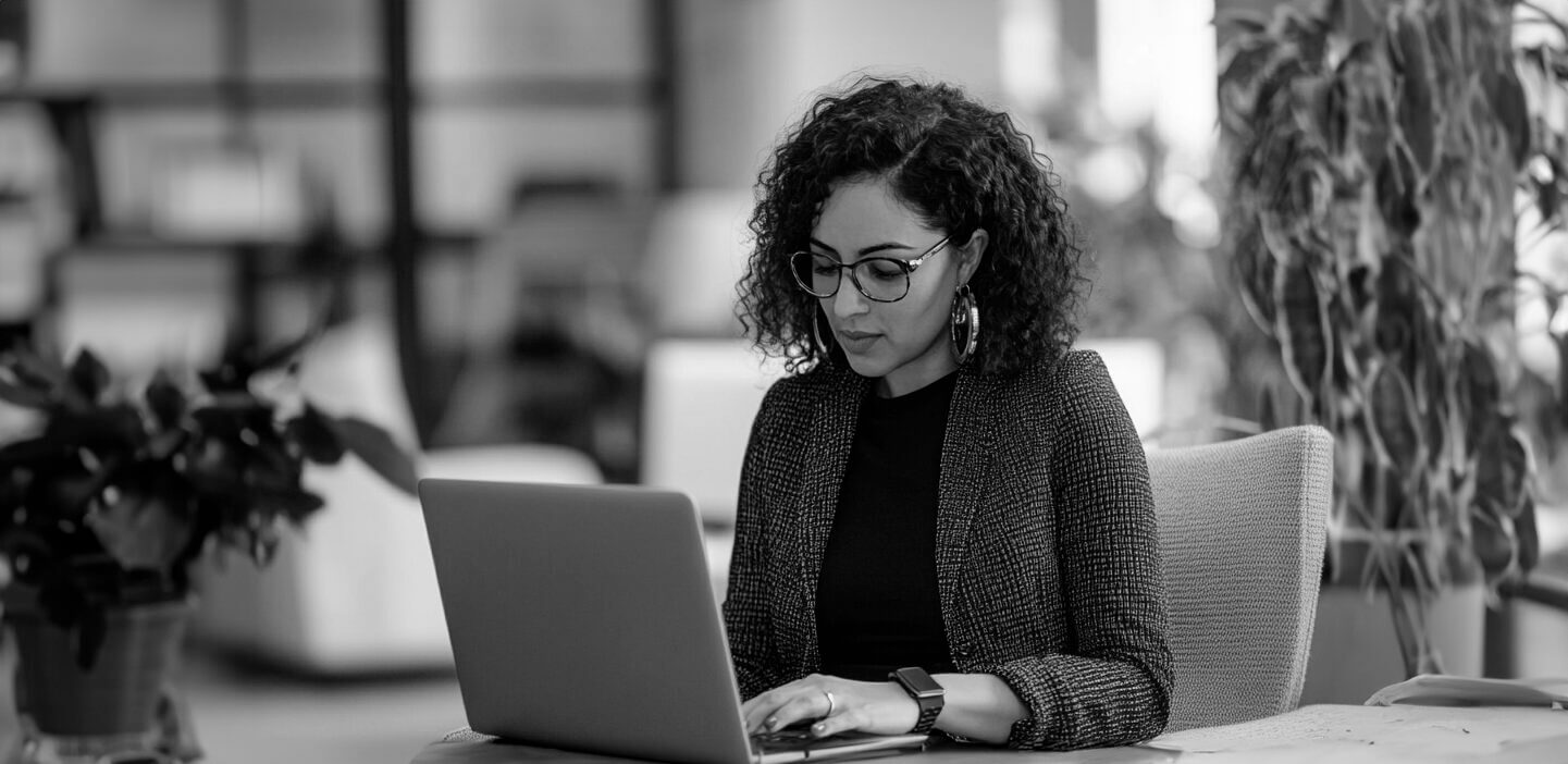 Woman typing at laptop computer