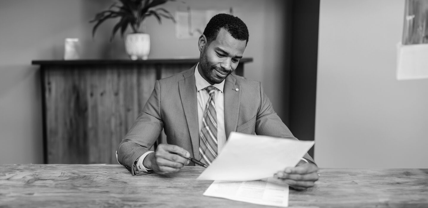 Man reviewing paperwork before signing