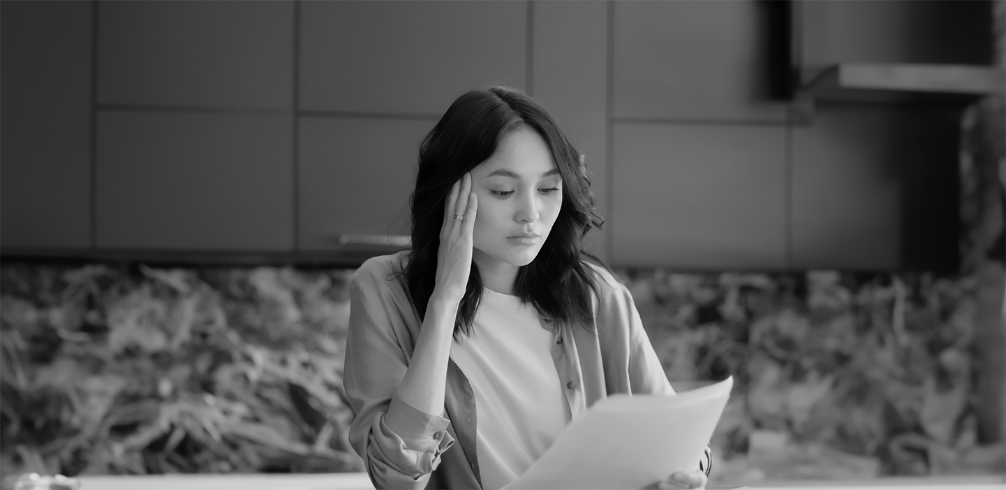 Woman reading a policy, looking confused